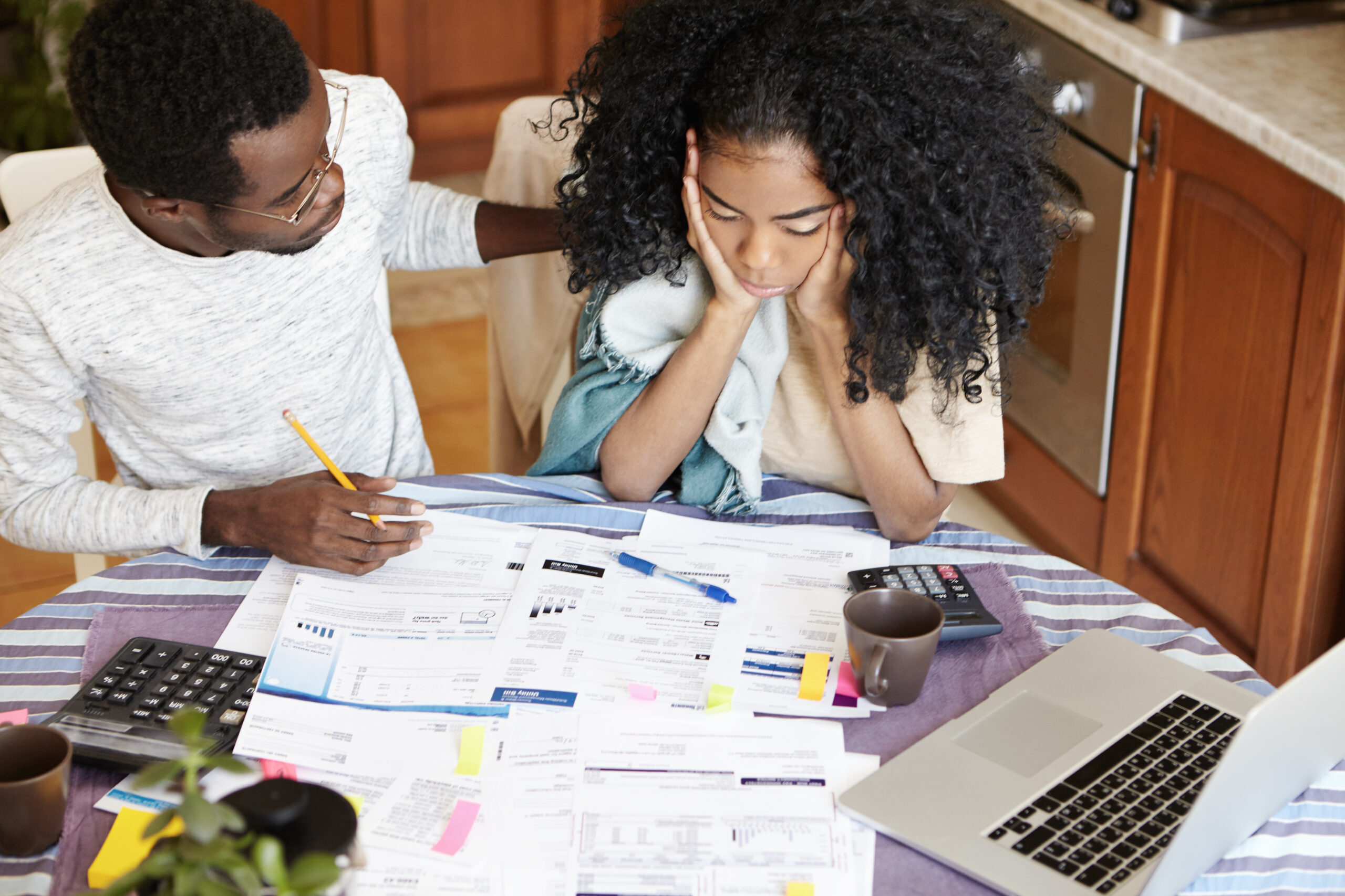 Woman reviewing financial documents at home with family