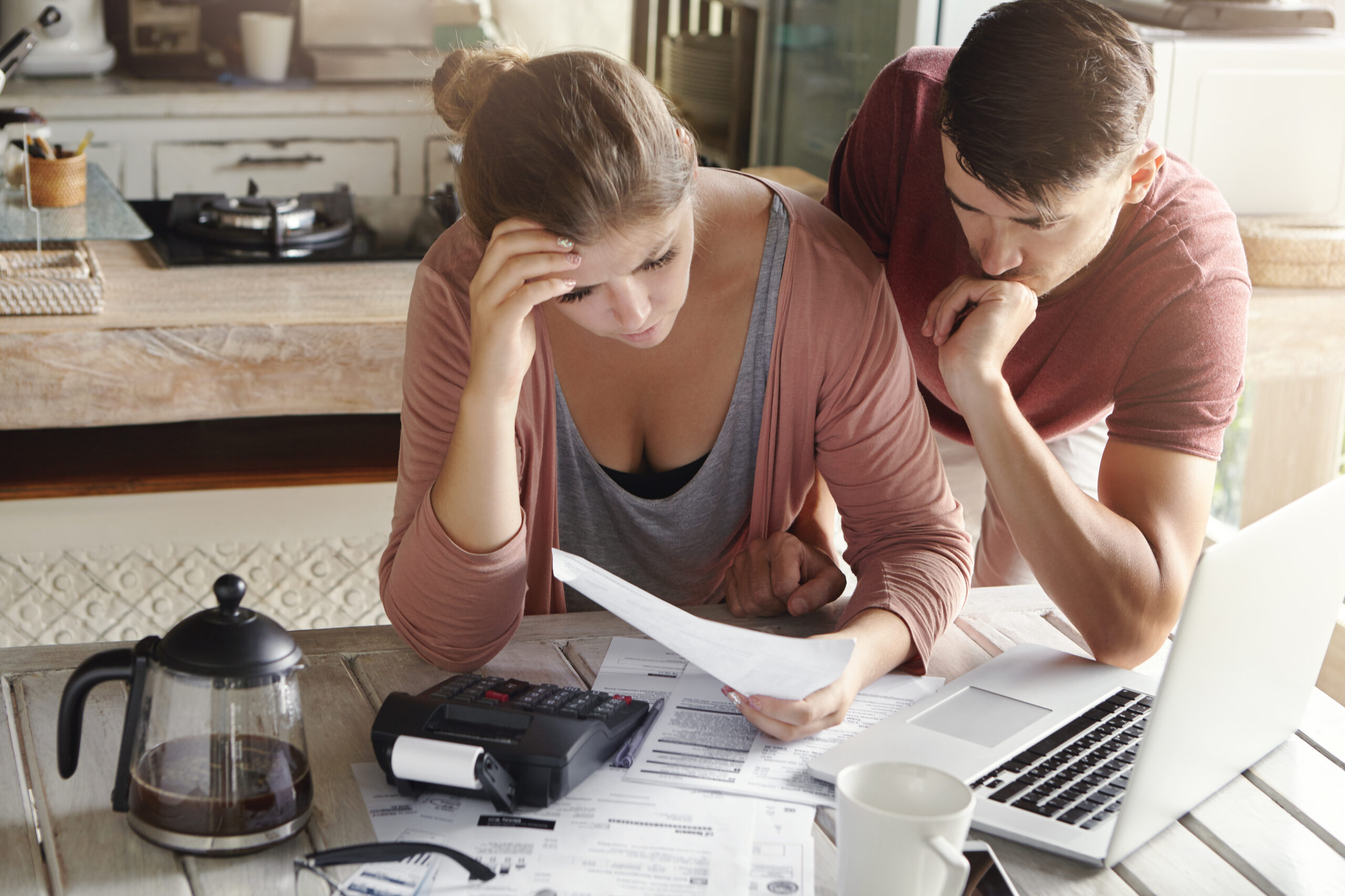 Woman reviewing financial documents at home with family