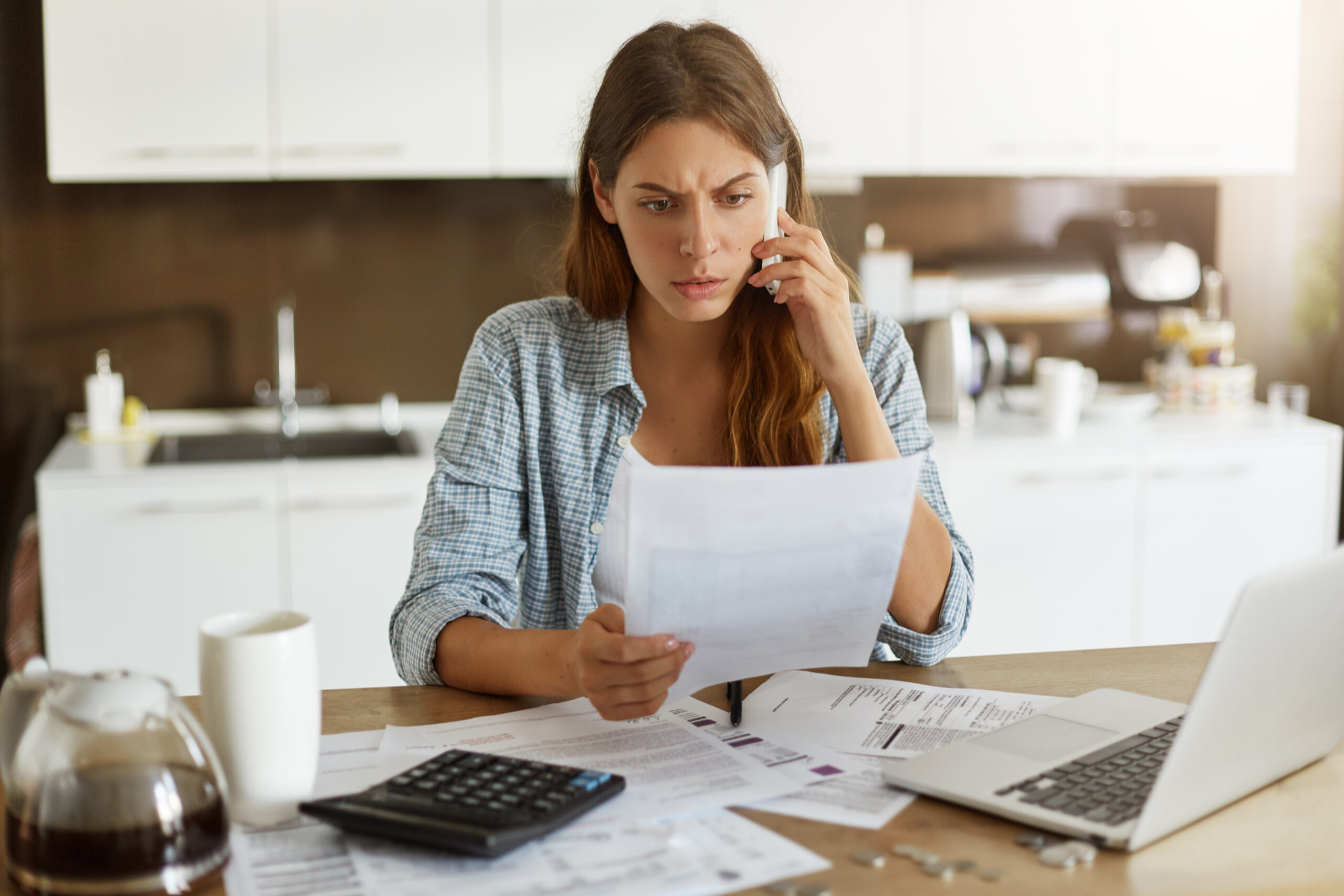 Woman reviewing documents while on call